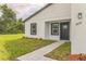 Charming home featuring a well-manicured lawn, inviting walkway, and modern exterior paint at 3832 Sw 157Th Place Rd, Ocala, FL 34473