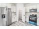 Kitchen showcasing new stainless steel appliances, modern cabinets, and convenient pantry access at 3832 Sw 157Th Place Rd, Ocala, FL 34473