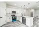 Bright kitchen features white cabinetry, stainless steel appliances, and a modern island at 3832 Sw 157Th Place Rd, Ocala, FL 34473