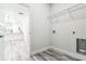 A laundry room with shelving and connections with light wood-look flooring at 3832 Sw 157Th Place Rd, Ocala, FL 34473