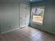 The bedroom provides a comfortable space with a window allowing ample natural light at 3917 Lake Mira Dr, Orlando, FL 32817