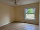The bedroom provides a comfortable space with a window allowing ample natural light at 3917 Lake Mira Dr, Orlando, FL 32817
