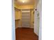 Walk-in closet featuring wood floors and open shelving at 3917 Lake Mira Dr, Orlando, FL 32817