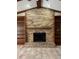 A close up of the brick fireplace with built in shelving on either side and tiled floors at 3917 Lake Mira Dr, Orlando, FL 32817