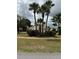 Charming single-story home featuring well-maintained front yard with palm trees and beautiful landscaping at 3917 Lake Mira Dr, Orlando, FL 32817