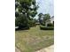 Charming single-story home featuring well-maintained front yard with lush trees and landscaping at 3917 Lake Mira Dr, Orlando, FL 32817