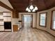 Open kitchen area with tile floors, wood ceiling beams, and doorway at 3917 Lake Mira Dr, Orlando, FL 32817