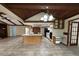 Open-concept kitchen with an island, black appliances, tiled floors, and a vaulted ceiling at 3917 Lake Mira Dr, Orlando, FL 32817
