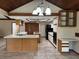 Kitchen showcasing tiled floors, a kitchen island, a cooktop, and white cabinets and countertops at 3917 Lake Mira Dr, Orlando, FL 32817