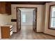 Kitchen area with tile floors, wood ceiling beams, doorway and wooden cabinets at 3917 Lake Mira Dr, Orlando, FL 32817