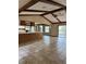 Open concept living area featuring tile flooring, wood ceiling beams, and kitchen bar at 3917 Lake Mira Dr, Orlando, FL 32817
