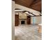 Expansive living area showcasing high vaulted ceilings with beams, a brick fireplace, and tiled flooring at 3917 Lake Mira Dr, Orlando, FL 32817