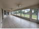 The screened-in patio offers an outdoor living space with ceiling fans and views of the backyard at 3917 Lake Mira Dr, Orlando, FL 32817