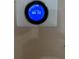 Nest thermostat hanging on wall, displaying the current temperature at 3917 Lake Mira Dr, Orlando, FL 32817