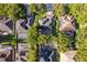 Aerial view of neighborhood homes with tree coverage and a community pool nearby at 394 Baymoor Way, Lake Mary, FL 32746