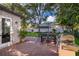 Outdoor patio area with a grill, a dining table with an umbrella, and a well-manicured lawn at 394 Baymoor Way, Lake Mary, FL 32746