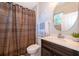 Bathroom with a shower/tub combo, a modern vanity, a decorative mirror, and a window for natural light at 394 Baymoor Way, Lake Mary, FL 32746