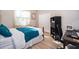 Cozy bedroom with a bright window, closet, and study corner with a sleek black desk and chair at 394 Baymoor Way, Lake Mary, FL 32746