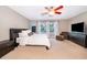 Spacious bedroom featuring neutral decor, bright windows, and cozy carpets for a comfortable retreat at 394 Baymoor Way, Lake Mary, FL 32746