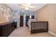 Bedroom with unique wall art, large dresser, and a comfy bed, creating a personalized space at 394 Baymoor Way, Lake Mary, FL 32746
