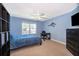 Cozy bedroom with blue walls, a comfortable bed, a ceiling fan, and a dark dresser set at 394 Baymoor Way, Lake Mary, FL 32746