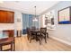 Dining area with dark wood table, stylish pendant lighting, and a pass-through window to the kitchen at 394 Baymoor Way, Lake Mary, FL 32746