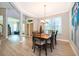 Elegant dining room with wood-look tile flooring and stylish light fixture at 394 Baymoor Way, Lake Mary, FL 32746