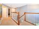 Hallway with carpeted floors, white wood banisters, and lots of natural light from the upper level at 394 Baymoor Way, Lake Mary, FL 32746