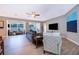 Spacious living room with wood-look tile floors and backyard views at 394 Baymoor Way, Lake Mary, FL 32746