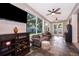 Bright living room features tile floors, a wine bar, and an arcade game for indoor entertainment at 394 Baymoor Way, Lake Mary, FL 32746