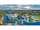 Aerial view showcasing the community's water park with pools, waterslides, playgrounds, and expansive green spaces at 421 Southfield St, Kissimmee, FL 34747