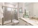 Bathroom featuring a glass-enclosed shower with tile, toilet, and marble countertop sink at 421 Southfield St, Kissimmee, FL 34747