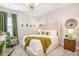 Bedroom with a queen bed with green accents, an accent chair, soft carpet, and natural light at 421 Southfield St, Kissimmee, FL 34747