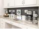 Stylish coffee bar area with white cabinets, granite countertop, and coffee-themed decor at 421 Southfield St, Kissimmee, FL 34747