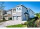 Gorgeous two-story home with a two-car garage, beautiful stone accents, and manicured landscaping with green grass at 421 Southfield St, Kissimmee, FL 34747