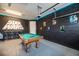 Basement game room featuring a pool table, bar stools, and themed wall art at 421 Southfield St, Kissimmee, FL 34747