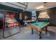 Spacious game room with Star Wars themed decor, pool table, basketball hoop and custom flooring at 421 Southfield St, Kissimmee, FL 34747