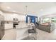 Bright, modern kitchen with stainless steel appliances and granite island, flowing into cozy living space at 421 Southfield St, Kissimmee, FL 34747