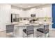 Modern kitchen featuring white cabinets, stainless steel appliances, and a granite-topped island with seating at 421 Southfield St, Kissimmee, FL 34747
