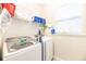 Bright laundry room with modern washer, dryer, and storage shelves at 421 Southfield St, Kissimmee, FL 34747