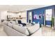 Open-concept living area connecting the living room with modern furniture to the bright, spacious kitchen at 421 Southfield St, Kissimmee, FL 34747