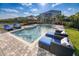 Stunning backyard pool with lounge chairs, patio furniture, and sunny skies makes it perfect for relaxation and entertaining at 421 Southfield St, Kissimmee, FL 34747