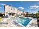 Beautiful pool with a spa and an outdoor dining space with an umbrella for the perfect spot to cool off during the summer at 421 Southfield St, Kissimmee, FL 34747