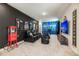 Home theater room with comfortable seating, movie posters, and a large projection screen at 421 Southfield St, Kissimmee, FL 34747
