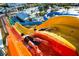 A colorful waterslide with two people enjoying the ride, offering a thrilling experience at the community's water park at 421 Southfield St, Kissimmee, FL 34747