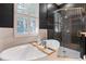 Luxurious bathroom with a freestanding tub, a glass-enclosed shower, and designer fixtures for a spa-like experience at 4310 Ethan Lane Ln, Orlando, FL 32814