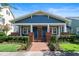 Charming blue home featuring a brick pathway leading to a cozy front porch with stately columns at 4310 Ethan Lane Ln, Orlando, FL 32814