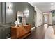 Entry hall featuring dark wood floors, decorative green wall trim, and stylish sideboard at 4310 Ethan Lane Ln, Orlando, FL 32814