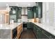 Bright kitchen featuring green cabinetry, stainless appliances, white countertops, and a marble island at 4310 Ethan Lane Ln, Orlando, FL 32814