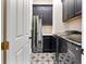 Laundry room with black cabinets, modern appliances, and decorative tiled flooring at 4310 Ethan Lane Ln, Orlando, FL 32814